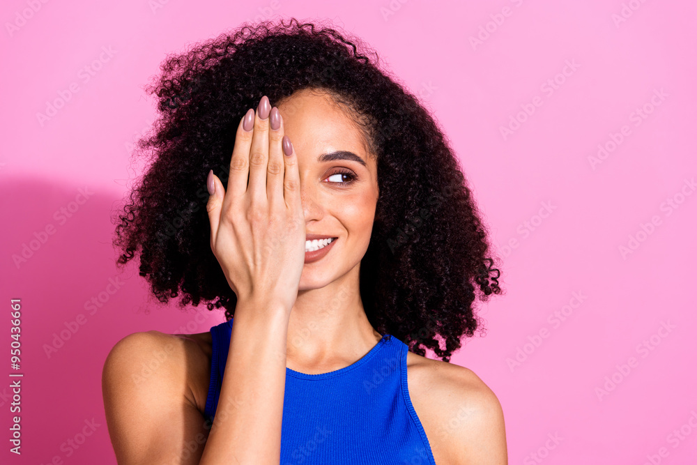 Photo portrait of attractive young woman cover hide face look empty space dressed stylish blue clothes isolated on pink color background Photo portrait of attractive young woman cover hide face look empty space dressed stylish blue clothes isolated on pink color background