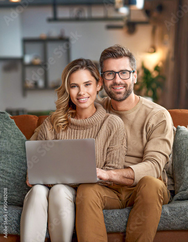 Young couple ordering online, looking in laptop 