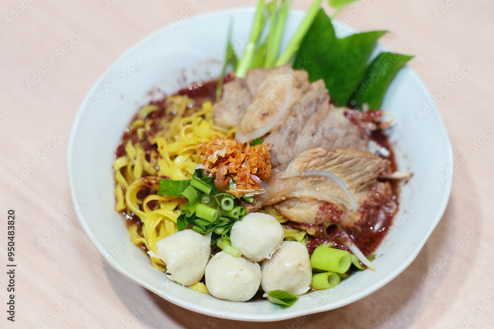 Yellow noodles decorated with pork meatballs, sliced pork, vegetables and pork blood soup. Yellow noodles decorated with pork meatballs, sliced pork, vegetables and pork blood soup.