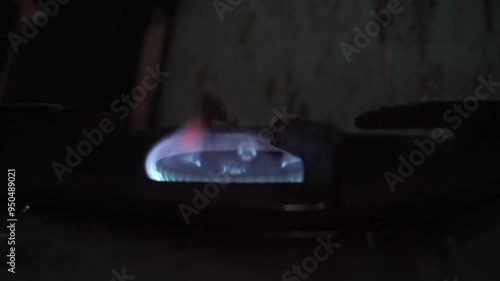 Close-up of a blue gas flame on a stovetop.