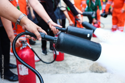 Fotografie Employees firefighting training, Concept Employees hand using fire extinguisher