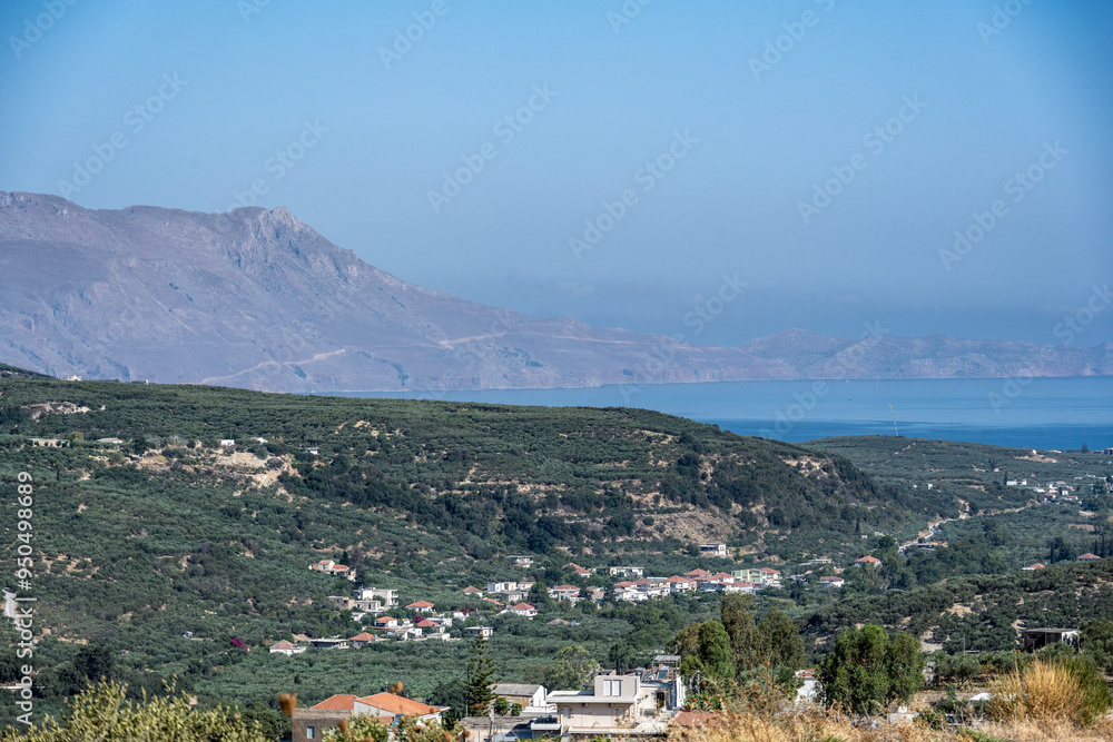panoramic view of ancient buildings against the backdrop of nature and mountain gardens on a sunny day on the island of Crete in Greece panoramic view of ancient buildings against the backdrop of nature and mountain gardens on a sunny day on the island of Crete in Greece