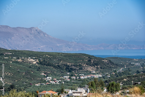 panoramic view of ancient buildings against the backdrop of nature and mountain gardens on a sunny day on the island of Crete in Greece