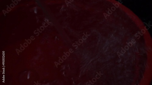 Close-up of boiling water with steam rising from the surface.
