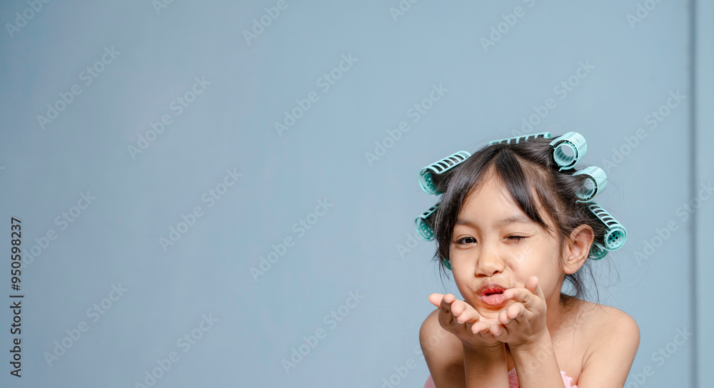 A girl is using hair rollers. hair curling, hair rollers, perm hair. A girl is using hair rollers. hair curling, hair rollers, perm hair.