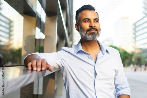 Indian businessman reflecting on future in urban setting