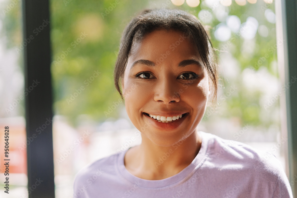 Attractive African American woman smiling looking happy wearing purple shirt, dental care Attractive African American woman smiling looking happy wearing purple shirt, dental care