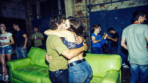 Spontaneous and joyful hug between ravers amid vibrant warehouse party atmosphere