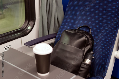 Business trip on the train with coffee and backpack
