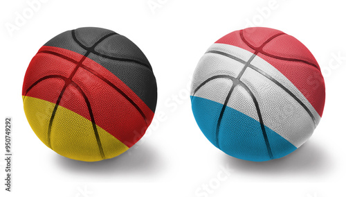 basketball balls with the national flags of luxembourg and germany on the white background. photo