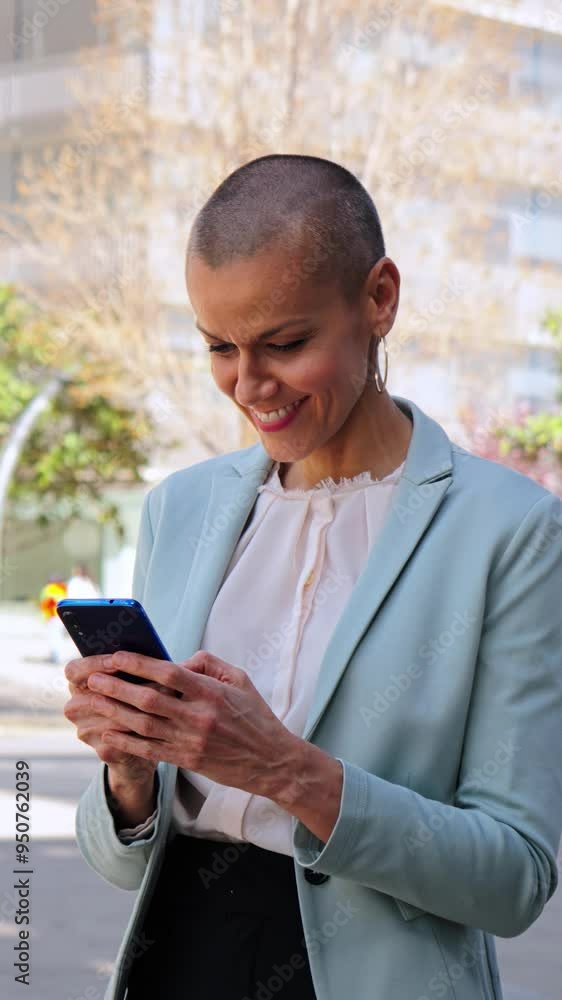 Vertical. successful business woman with suit and short hair, winning with stock shares on cellphone invest app. Corporate female worker using a mobile phone to browse and share on the social media Vertical. successful business woman with suit and short hair, winning with stock shares on cellphone invest app. Corporate female worker using a mobile phone to browse and share on the social media