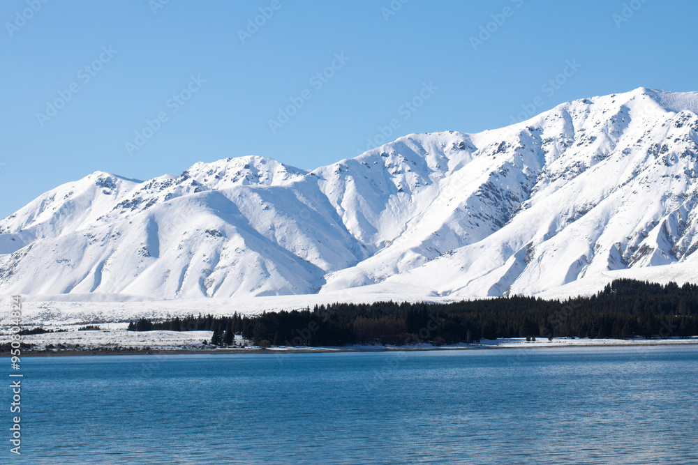 Lake Tekapo in New Zealand in winter. Stunning view of the snow-capped mountains Lake Tekapo in New Zealand in winter. Stunning view of the snow-capped mountains