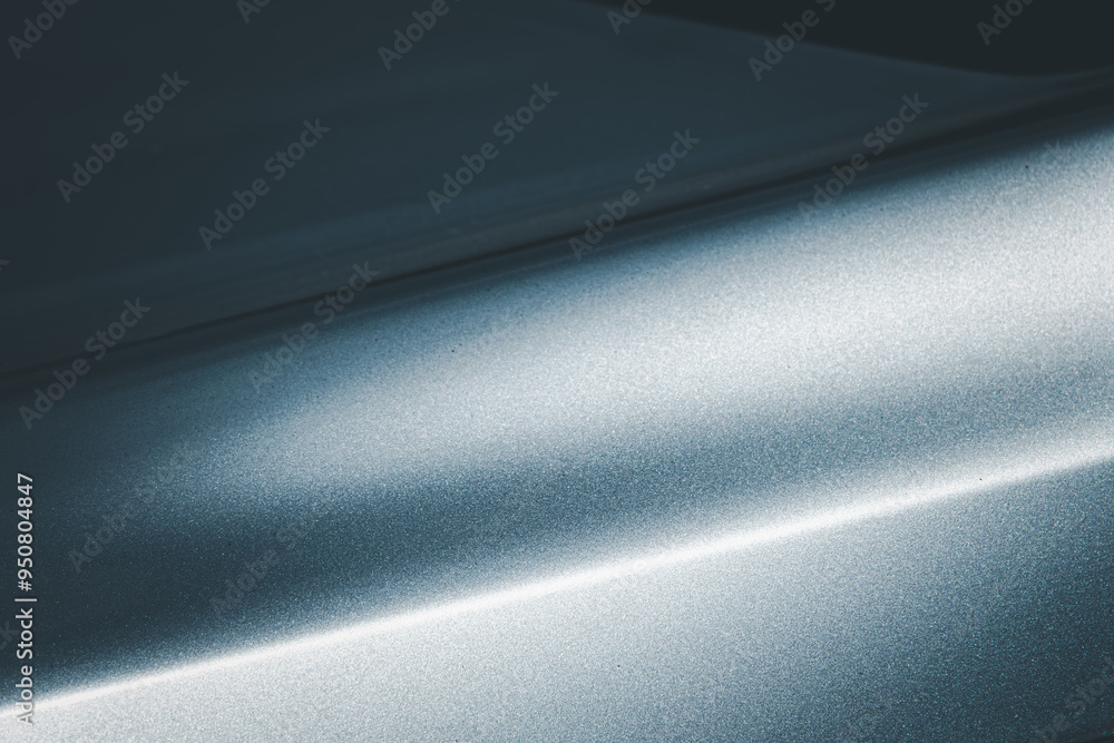 A shiny silver surface with a blue tint. The surface is reflective and has a metallic sheen A shiny silver surface with a blue tint. The surface is reflective and has a metallic sheen