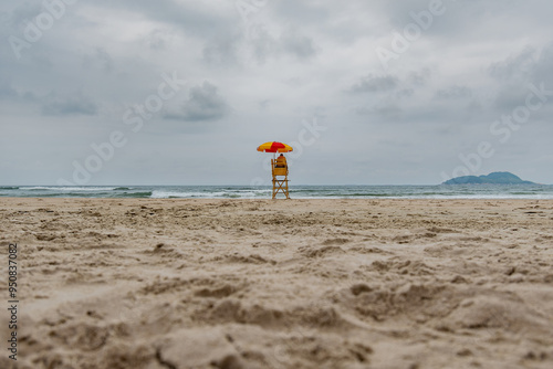 Beach lifeguard in the middle of the beach on a cloudy day and no people on the sea. Tombo beach, Guaruja - SP, Brazil.