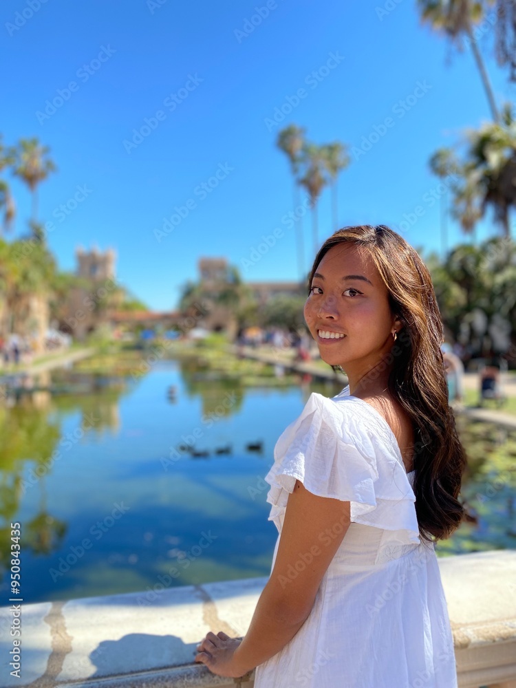 Asian girl smiling and posing in white dress in San Diego's Balboa park Asian girl smiling and posing in white dress in San Diego's Balboa park