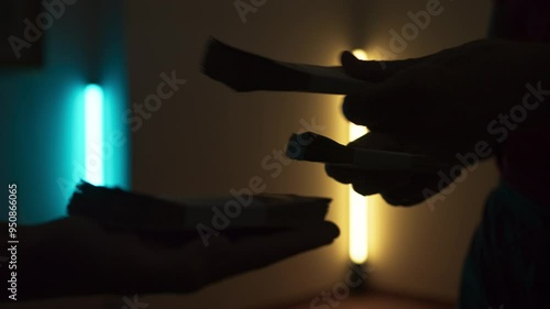 Silhouette Of Hands Passing Wad Of Corrupt Money photo