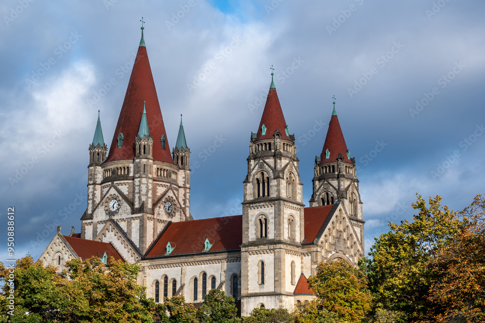 Vienna, Austria, August 23, 2022. Magnificent view of St. Francis Church. The red tiles stand out against the blue sky. Travel destinations. Vienna, Austria, August 23, 2022. Magnificent view of St. Francis Church. The red tiles stand out against the blue sky. Travel destinations.
