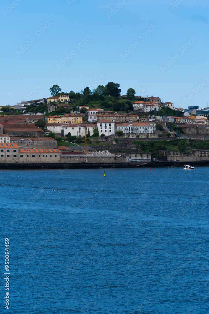 Obraz premium View of Porto city and Douro river and Dom Luis bridge. Porto, Vila Nova de Gaia, Portugal. Cityscape along the river