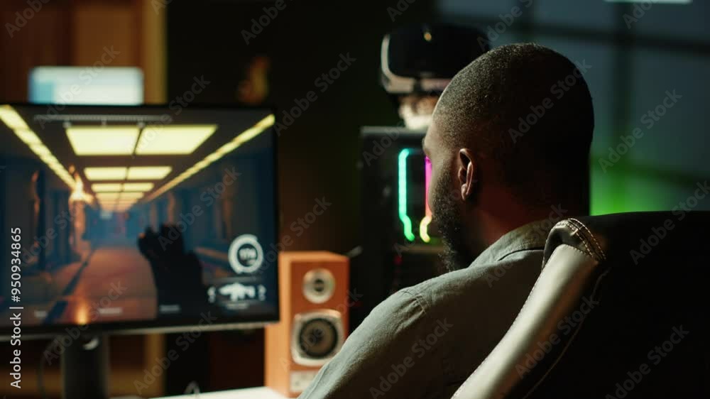 Man in neon lit apartment playing immersive video games on gaming PC at computer desk, handheld camera shot. Gamer competing against enemies in internet multiplayer shooter, camera A Man in neon lit apartment playing immersive video games on gaming PC at computer desk, handheld camera shot. Gamer competing against enemies in internet multiplayer shooter, camera A