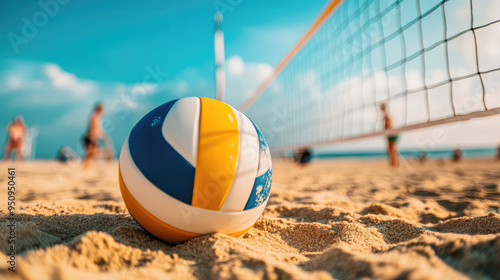 Volleyball lying on the sand of beach with a net in the background. blurred people player behind.