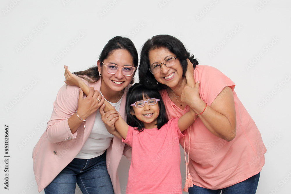 Three generations of brunette Latina women, grandmother, mom and daughter with glasses show their love and family support celebrate Mother's Day Three generations of brunette Latina women, grandmother, mom and daughter with glasses show their love and family support celebrate Mother's Day