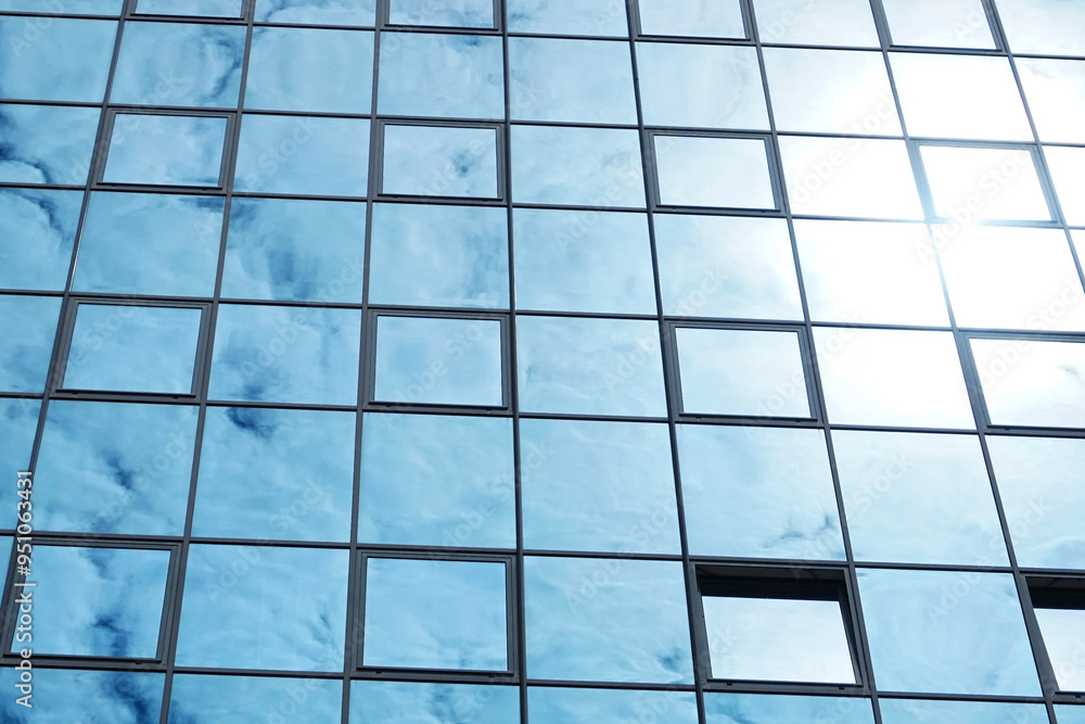 Office building texture. Glass skyscraper background. Glass window building. Sunny day architecture. Window sunlight reflection. Bright warm sunbeam on cold glass. Office building texture. Glass skyscraper background. Glass window building. Sunny day architecture. Window sunlight reflection. Bright warm sunbeam on cold glass.