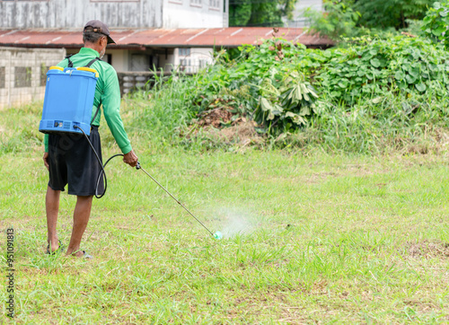 Old man sprays his yard back home