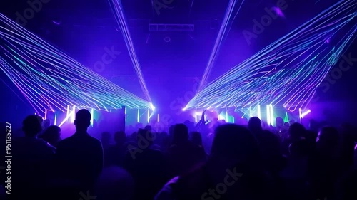 Crowd enjoying live music performance with laser lights