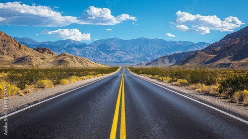 Close-up of the centerline of a highway winding between mountain peaks on a sunny day