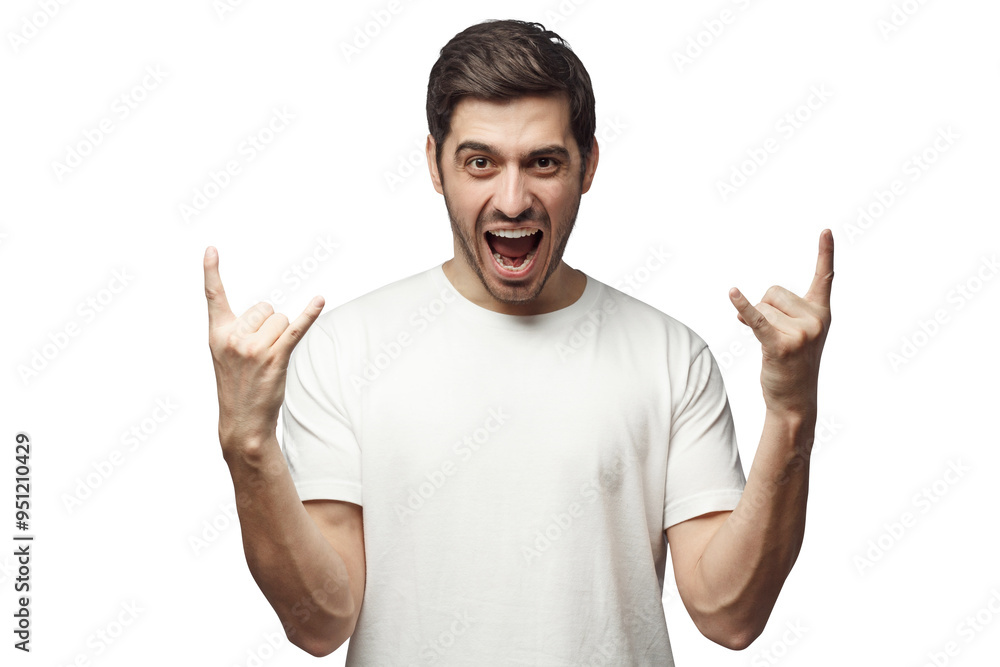 Young man showing rock gesture with his fingers as if listening to favourite music Young man showing rock gesture with his fingers as if listening to favourite music