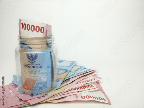 Various paper money of Indonesian rupiah. Concept of finance, investment, economy, business and success. Money in glass cup. Saving your money. Uang 10000 50000 Rupiah Indonesia