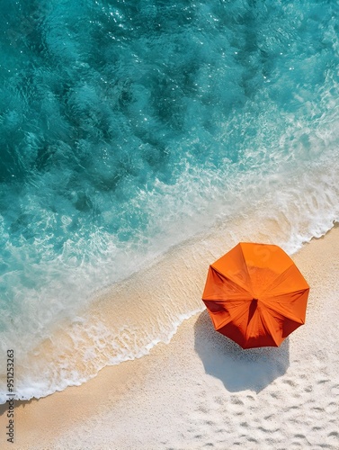 Aerial View of Vibrant Orange Sun Umbrella on Stunning Turquoise Beach Landscape