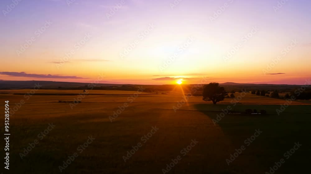 Stunning sunset over rolling hills with vibrant colors in the evening sky near the countryside landscape Stunning sunset over rolling hills with vibrant colors in the evening sky near the countryside landscape