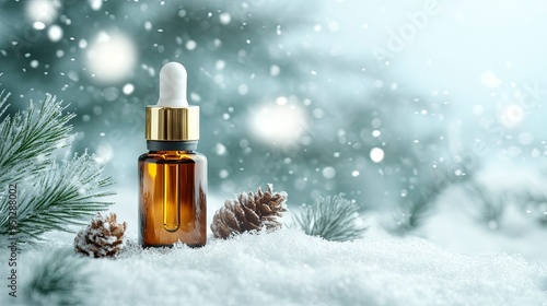 Glass bottle with serum, essential oil on blue background on the snow. winter cosmetic for face and hand skin care with vitamins. Copy space.