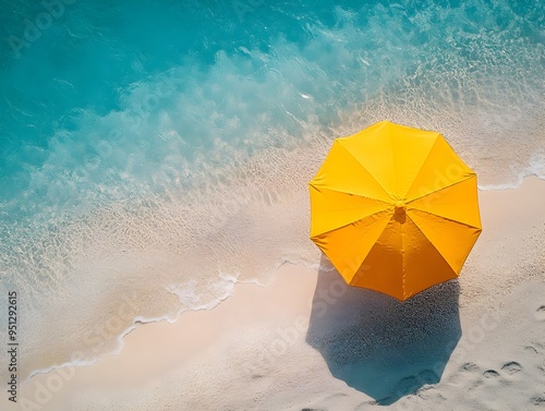 Aerial View of Vibrant Yellow Umbrella on Tranquil Summer Beach