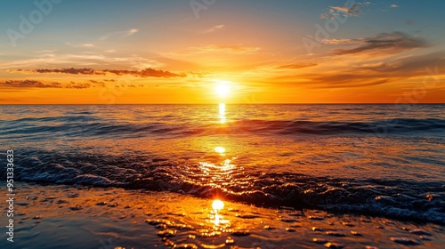 A stunning golden sunset over a smooth, undisturbed sea, the warm light gently illuminating the horizon and casting a serene ambiance in the clear weather photo