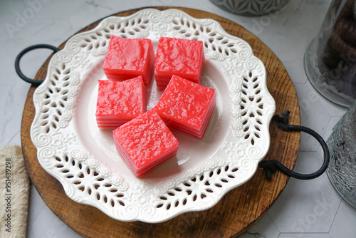 Kuih Lapis, a traditional Malay layered steamed cake and dessert, in white plates.