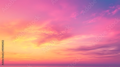 A vibrant pink and yellow sunset sky glows over the ocean, casting a warm, dreamy light across the horizon.