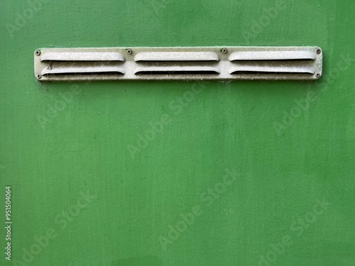 Ventilation slots on green wall