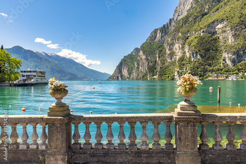 Lake Garda with mountains in background, view from Riva del Garda town shore, Italy, Europe. photo