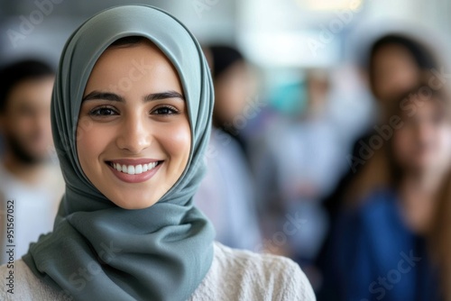 Smiling woman in hijab with diverse group in background