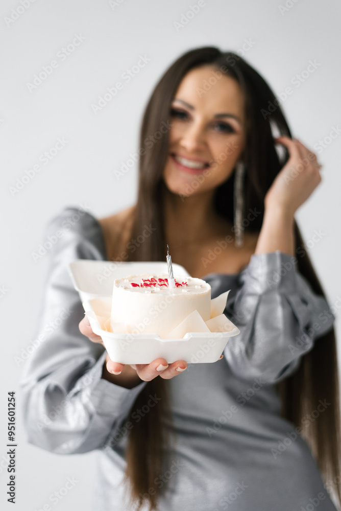 Birthday smiling woman is holding a cake in a plastic container Birthday smiling woman is holding a cake in a plastic container