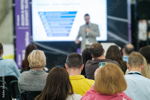 Wallpaper Mural Business professionals attending a conference presentation. Speaker giving lecture with slide presentation to engaged audience in a corporate event setting. Torontodigital.ca