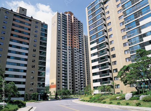 Bundang, Seongnam-si, Gyeonggi-do, South Korea - July 11, 2006: Low angle and summer view of high-rise apartments with road and garden