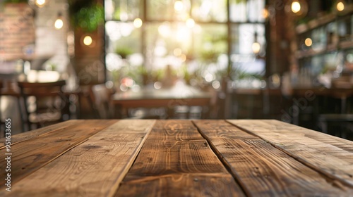 07231249 175. Focused wooden table surface with a dreamy, blurred backdrop of a stylish and modern restaurant, highlighting the social and inviting setting