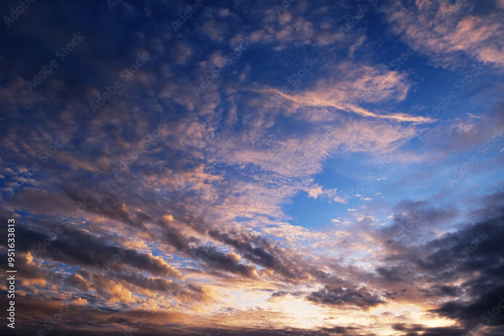 Fototapeta premium Cloudscape, Colored Clouds at Sunset near the Ocean in a Blue Sky