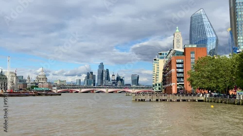 Pan across the River Thames at Blackfriars Bridge to the busy Southbank and iconic Oxo tower in the heart of London. photo