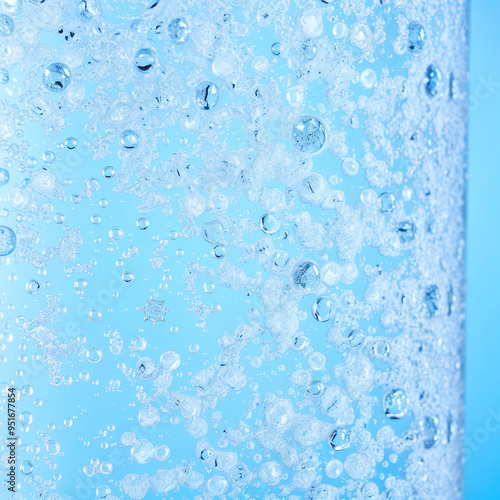 Sparkling Water Bubbles Rising in Light Blue Background Close-up Abstract photo