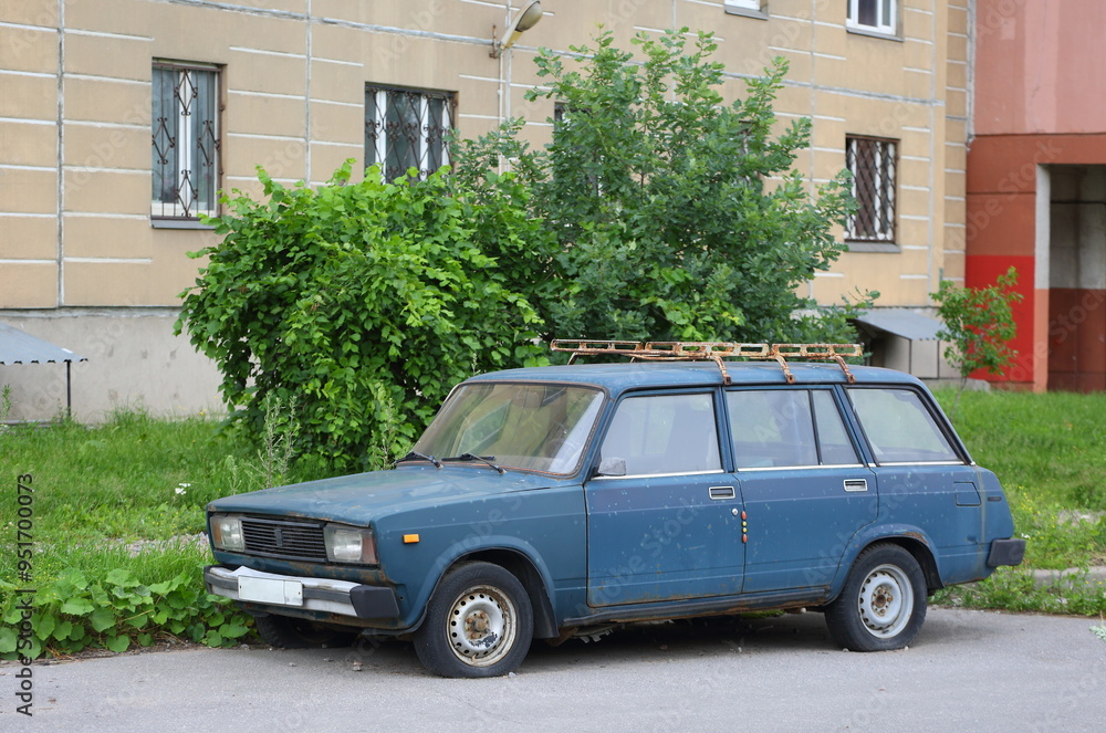 An old dark-green Soviet car in the courtyard of a residential building, Bolshevikov Avenue, St. Petersburg, Russia, June 19, 2024 An old dark-green Soviet car in the courtyard of a residential building, Bolshevikov Avenue, St. Petersburg, Russia, June 19, 2024