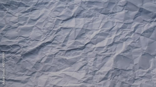 The background is in the form of crumpled paper, which changes quickly. Background for presentation titles and footage. Seamless loop.